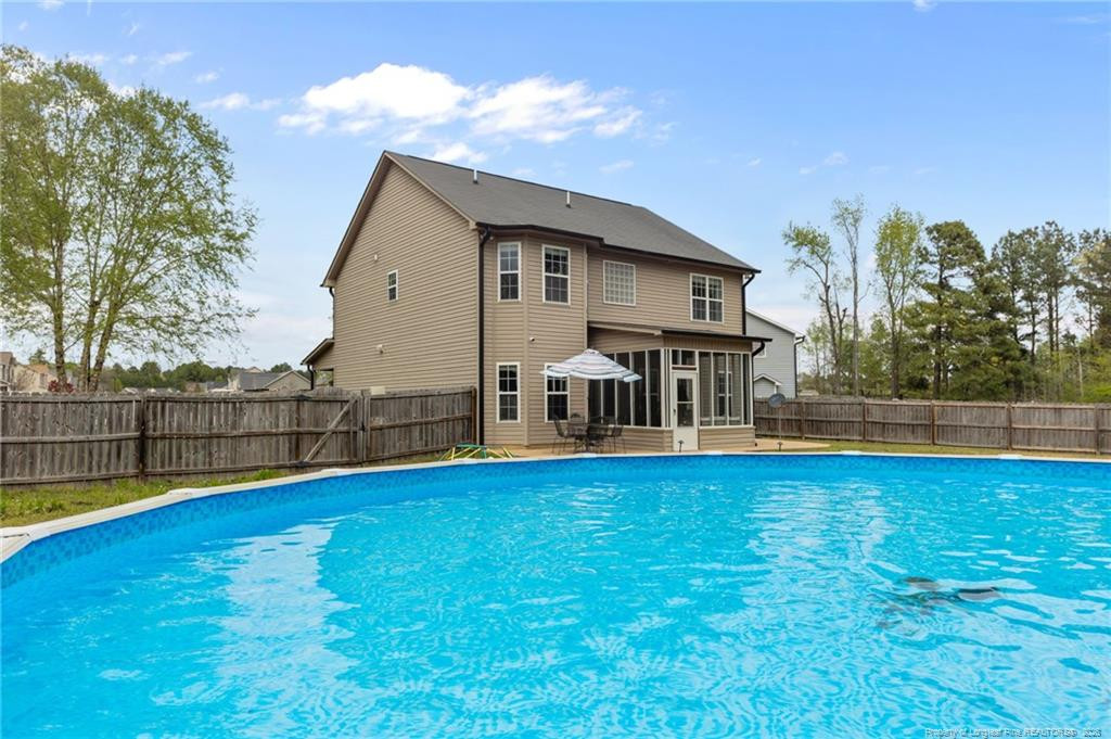 594 Allegiance Street Raeford, NC 28376 - Photo 41 of 49 a view of a house with pool and a yard