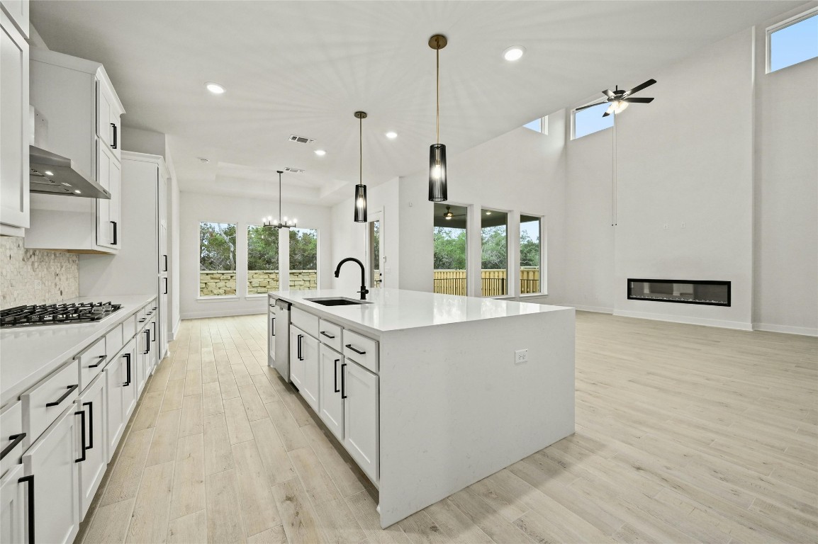 a kitchen with stainless steel appliances granite countertop a lot of counter space and wooden floors