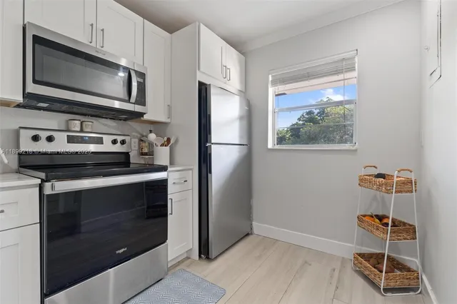 a kitchen with a refrigerator stove and microwave