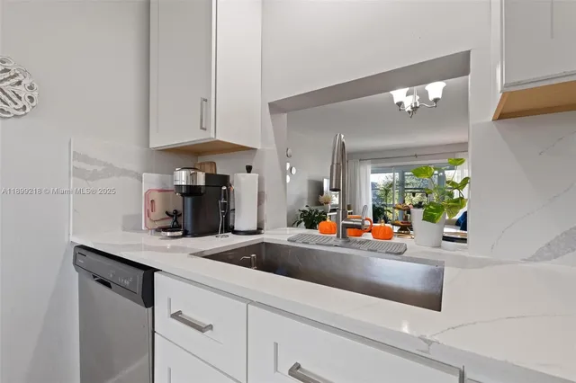 a kitchen with white cabinets and a sink