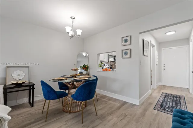 a view of a workspace with furniture and wooden floor