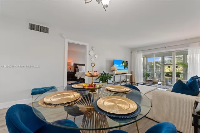 a dining room with furniture a wooden floor and a chandelier
