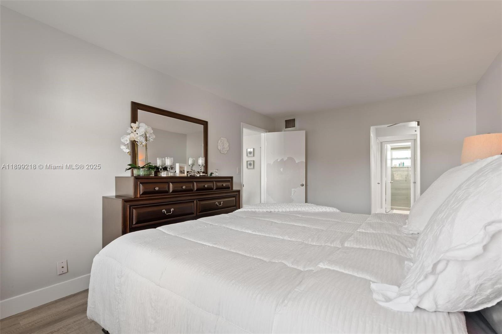 1501 South Ocean Boulevard, Unit 318 Lauderdale-by-the-Sea, FL 33062 - Photo 22 of 26 a bedroom with a bed and a dresser