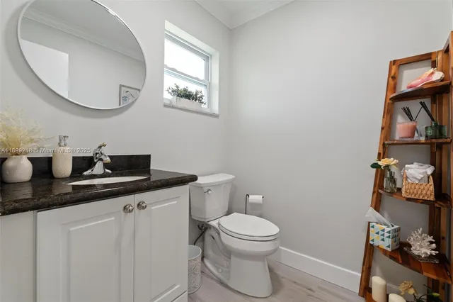a bathroom with a toilet a sink and mirror