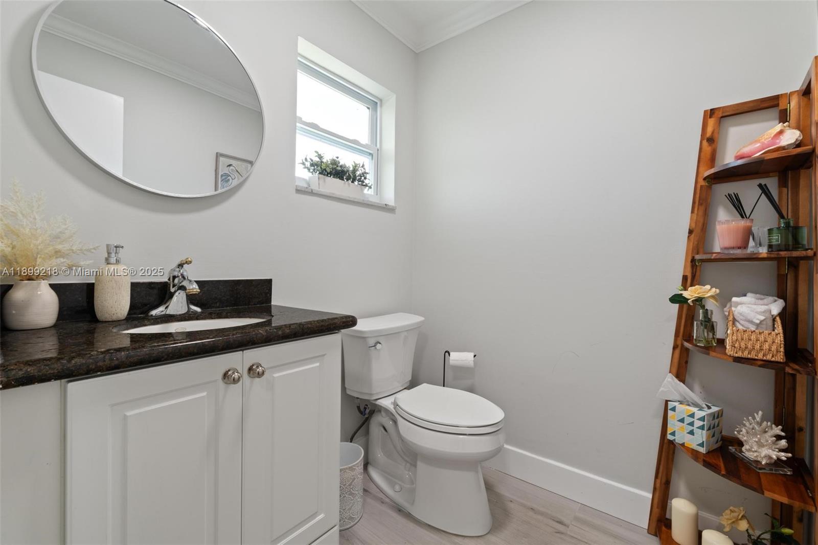 1501 South Ocean Boulevard, Unit 318 Lauderdale-by-the-Sea, FL 33062 - Photo 24 of 26 a bathroom with a toilet a sink and mirror