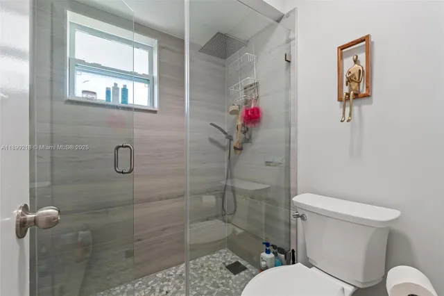 a bathroom with a toilet and a shower