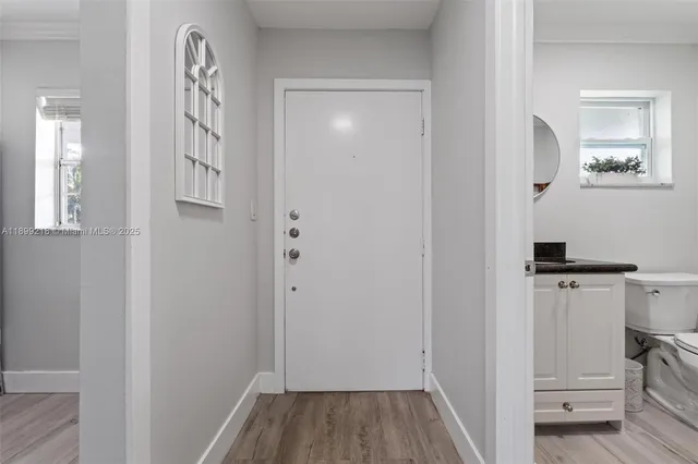 a view of hallway with wooden floor