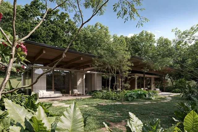 a view of a house with backyard and sitting area