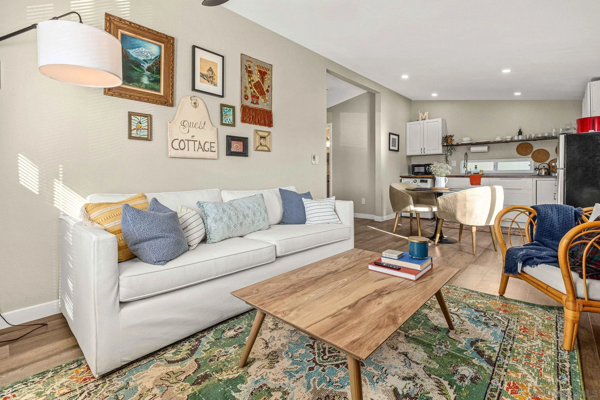 a living room with furniture and kitchen view