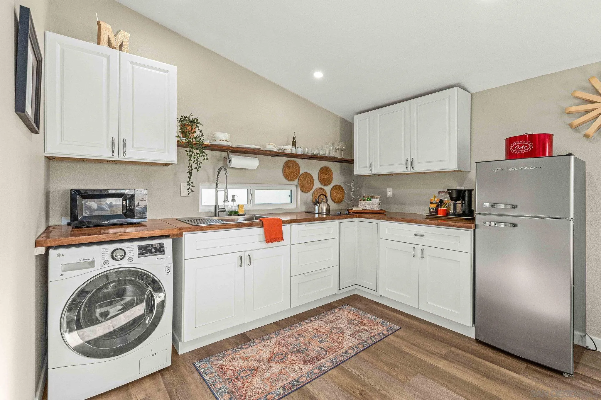 6081 Horton Drive, Unit CASITA La Mesa, CA 91942 - Photo 7 of 30 a kitchen with cabinets and wooden floor