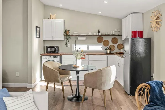 a utility room with cabinets washer and dryer