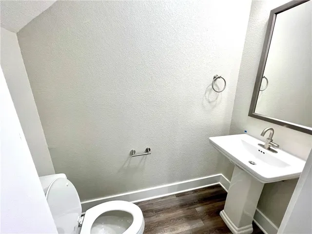 a bathroom with a sink mirror and toilet