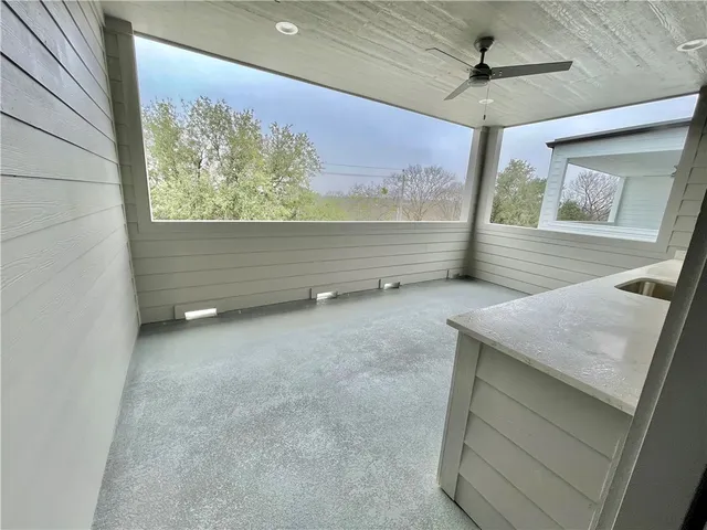 a view of room with window and a ceiling fan