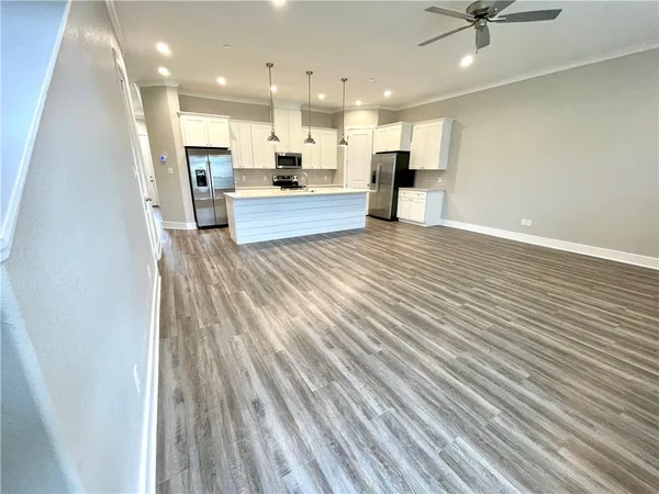 a view of kitchen with kitchen island microwave and stove