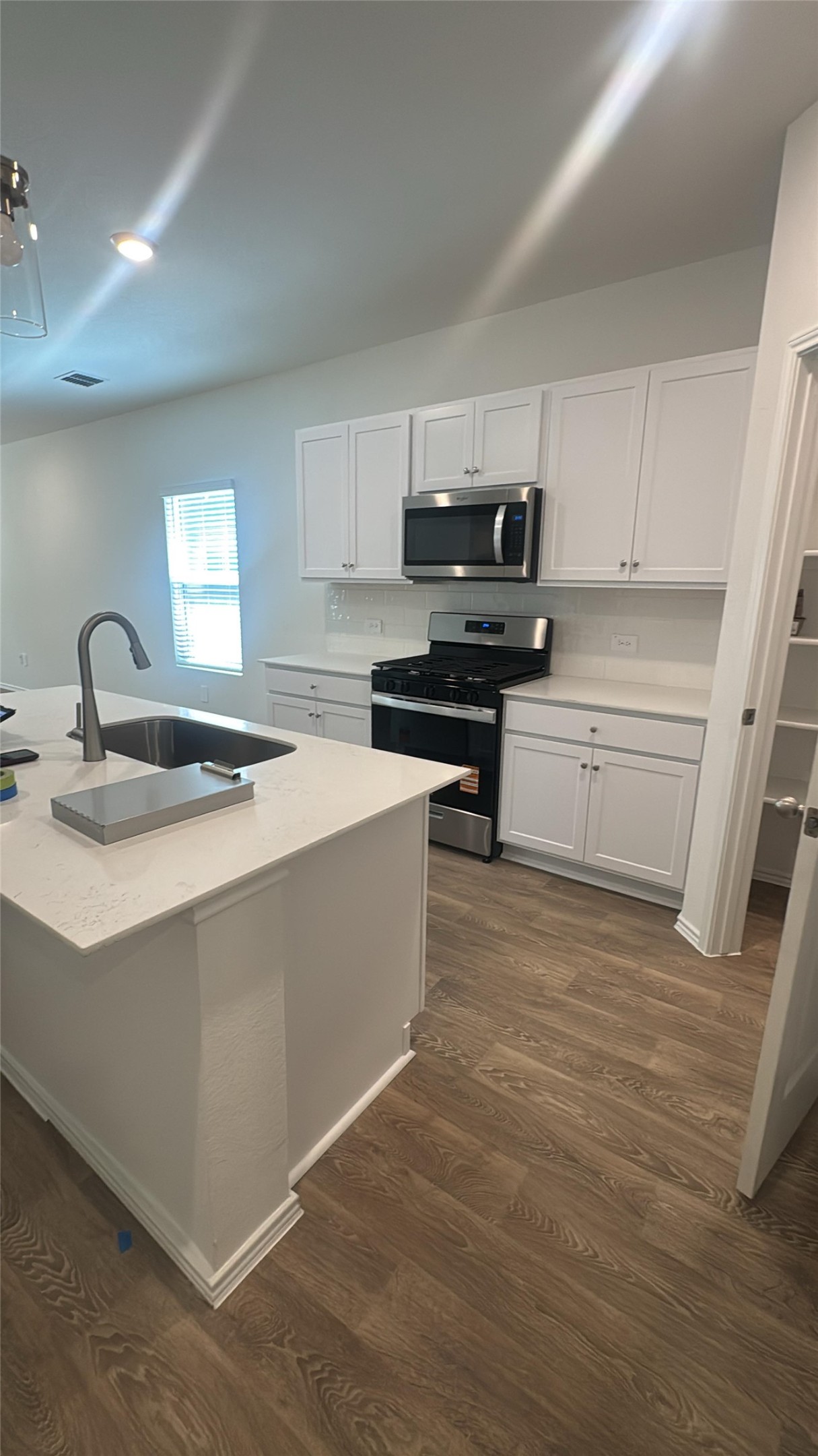 174 Balmorhea Street Kyle, TX 78640 - Photo 4 of 29 A well-appointed kitchen showcasing an island with sink and modern appliances.
