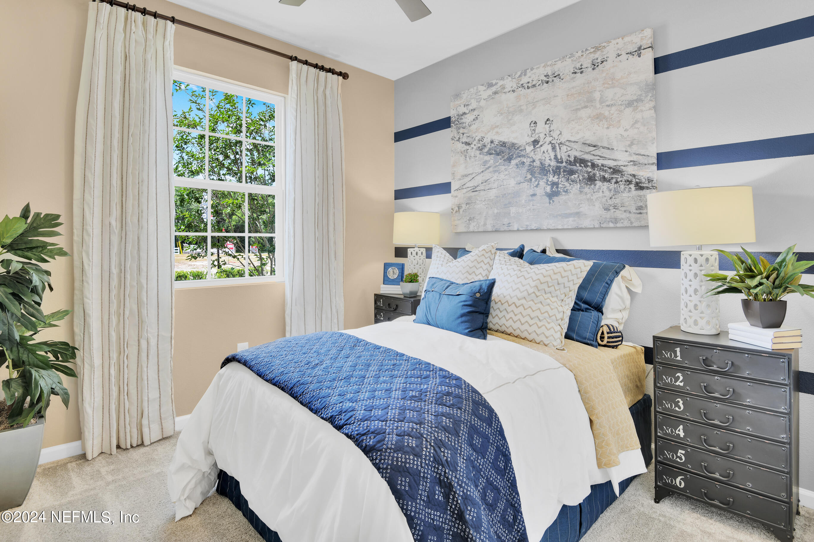 146 Arbor Alcove Lane St. Augustine, FL 32084 - Photo 17 of 18 a bedroom with a large bed and a potted plant