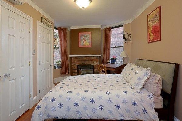 497 Beacon Street, Unit 9 Boston, MA 02215 - Photo 3 of 5 a bedroom with a bed and a refrigerator