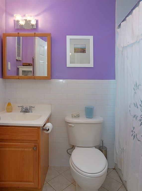 497 Beacon Street, Unit 9 Boston, MA 02215 - Photo 5 of 5 a bathroom with a toilet a sink and mirror