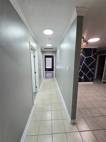 a view of a room with wooden floor and cabinets