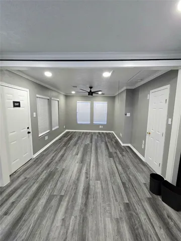 a view of a hallway with wooden floor