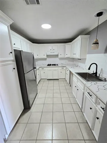 a kitchen with a sink and cabinets