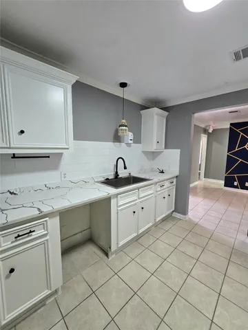 a kitchen with granite countertop cabinets and refrigerator