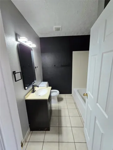 a bathroom with a sink toilet and mirror