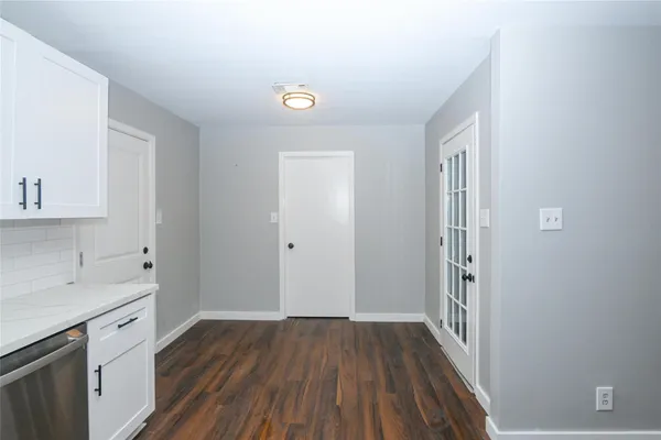 a view of a kitchen from the hallway