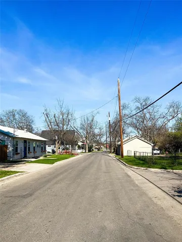 a view of a street with a building in the background