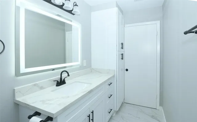 a bathroom with a sink and a mirror