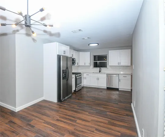 a view of a kitchen with electric appliances