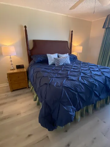 a bed sitting in a bedroom next to a lamp