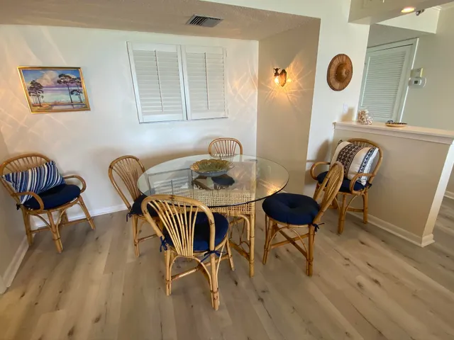 a view of a dining room with furniture and wooden floor
