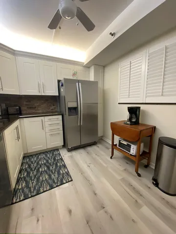 a kitchen with a refrigerator and a stove