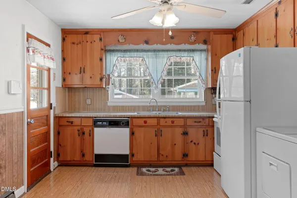 a kitchen with stainless steel appliances granite countertop a refrigerator and a stove
