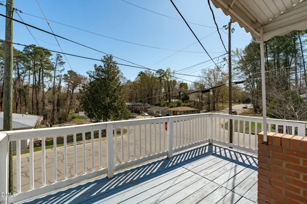 a view of a white house with a deck