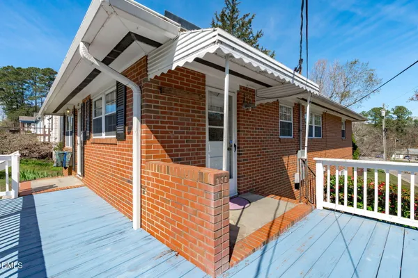 a view of a house with wooden deck