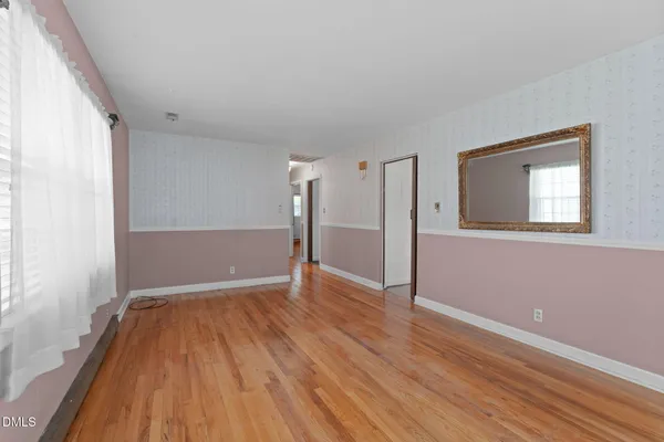 wooden floor in an empty room with a window