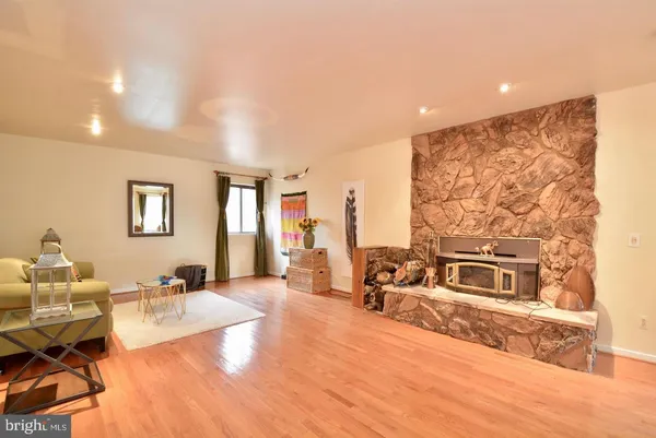 a view of a hallway with wooden floor and chandelier