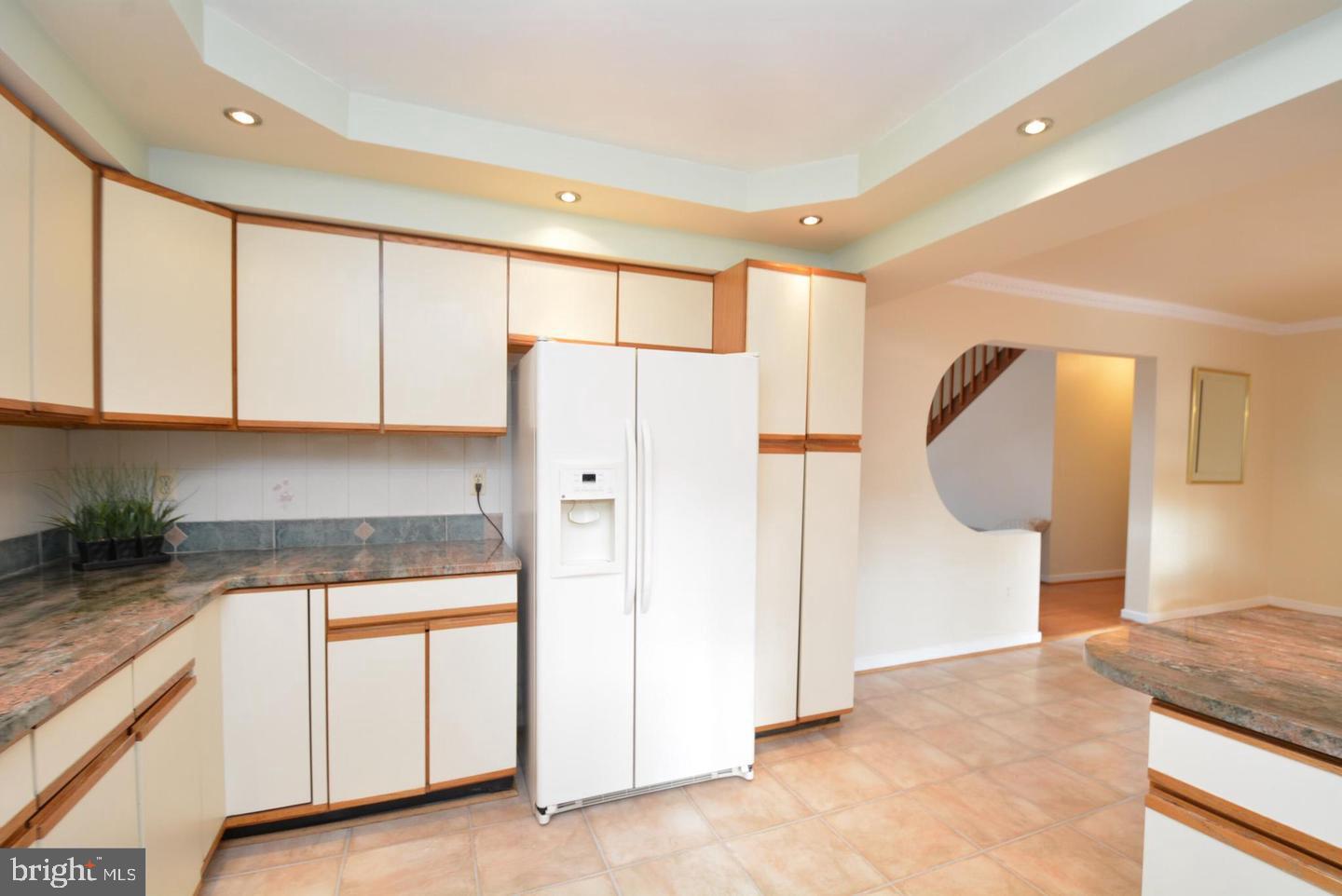 8421 Alvin Road Pasadena, MD 21122 - Photo 18 of 54 a kitchen with granite countertop white cabinets and refrigerator