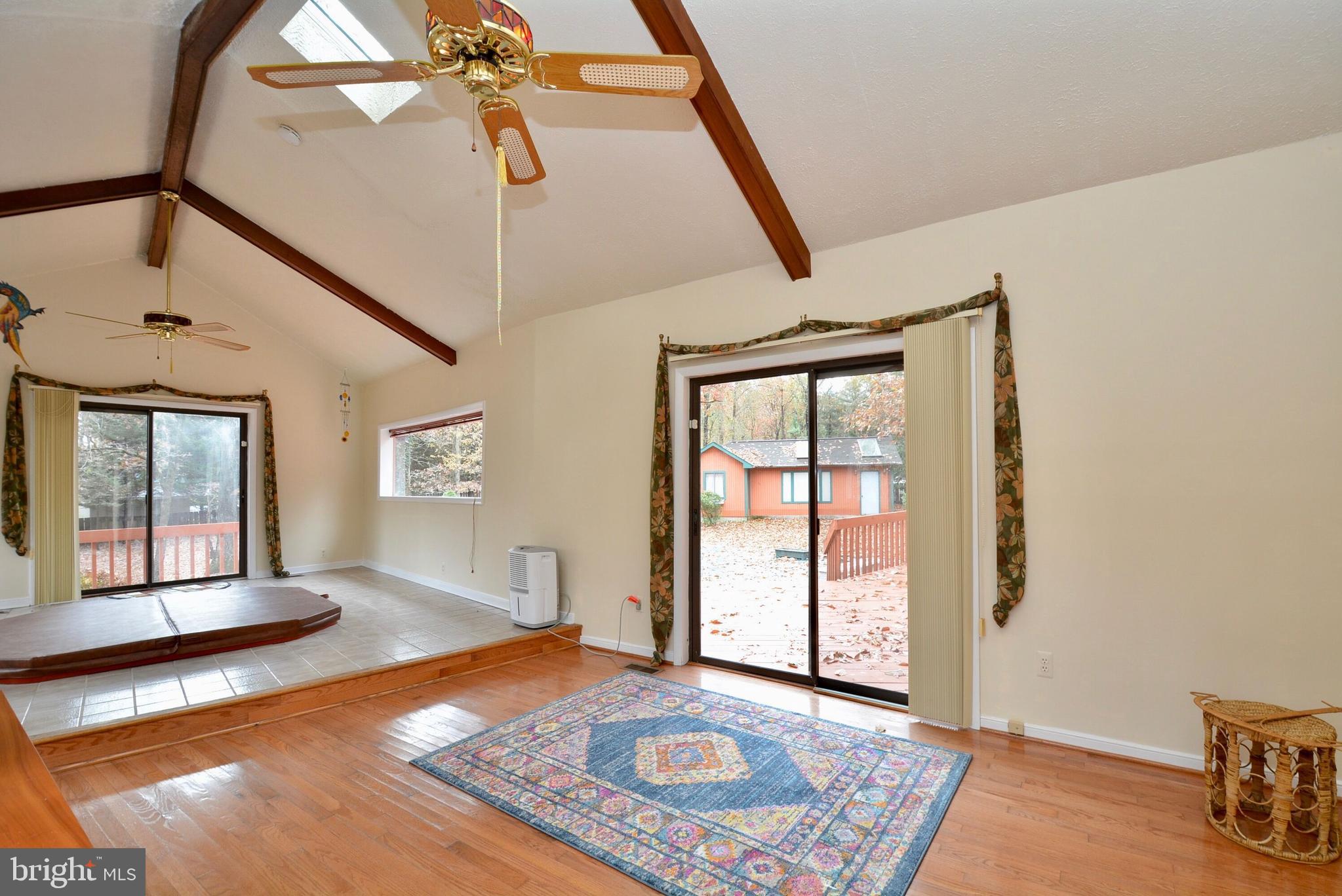 8421 Alvin Road Pasadena, MD 21122 - Photo 20 of 26 a view of an empty room with window and wooden floor