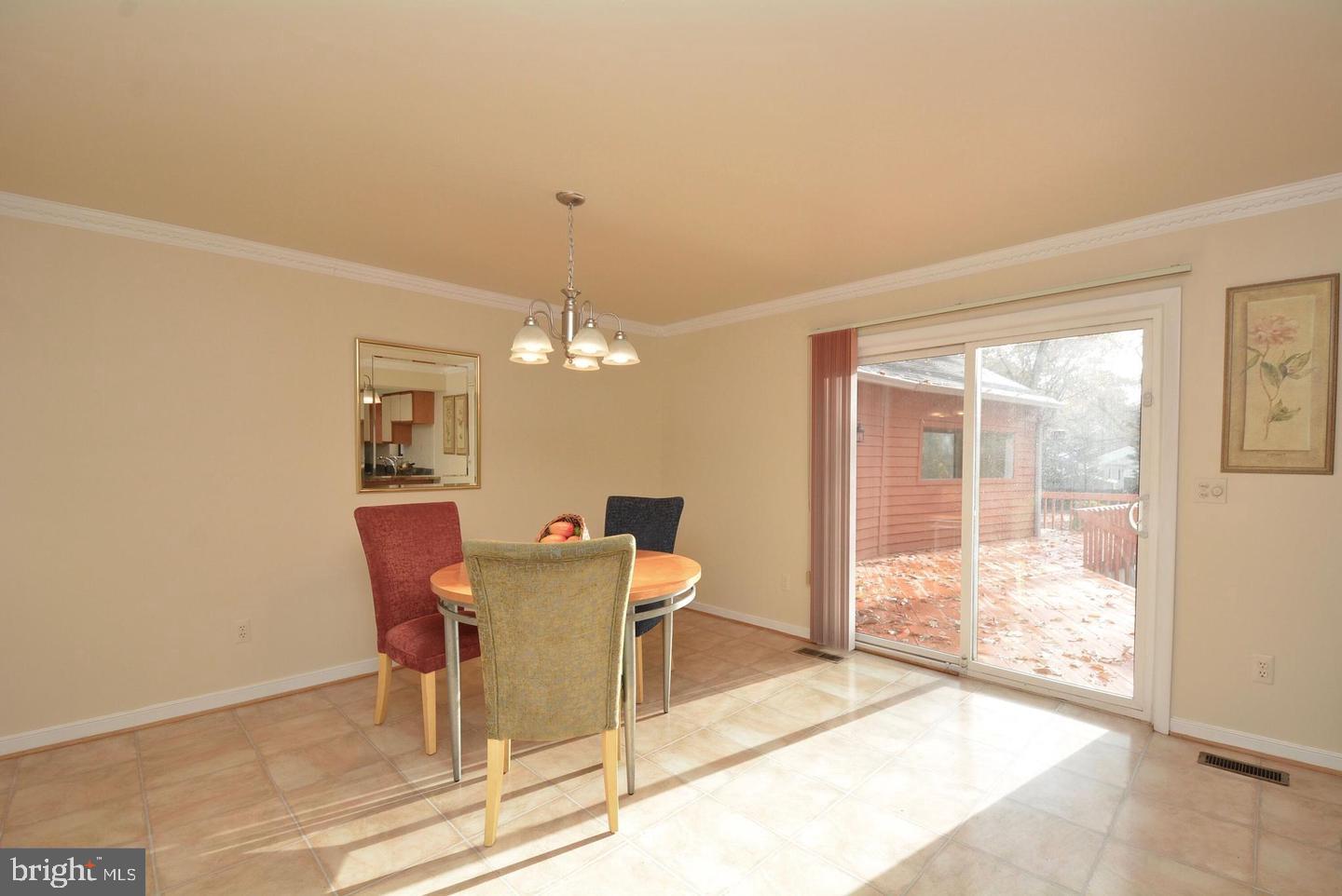 8421 Alvin Road Pasadena, MD 21122 - Photo 23 of 54 a view of a dining room with furniture and a floor to ceiling window
