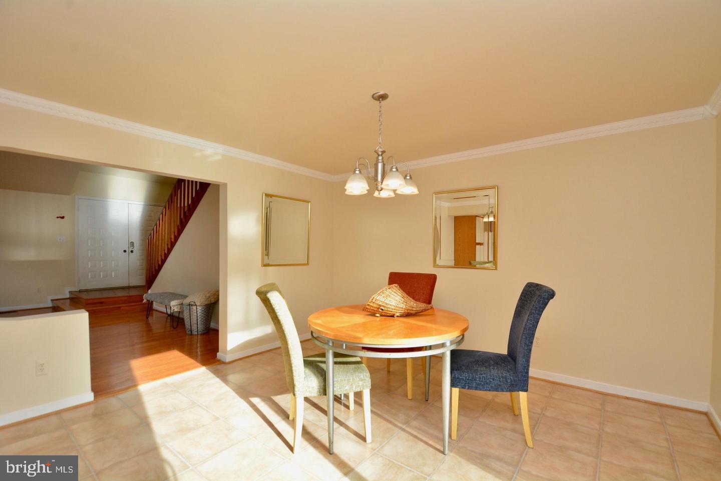 8421 Alvin Road Pasadena, MD 21122 - Photo 24 of 54 a dining room with furniture and chandelier