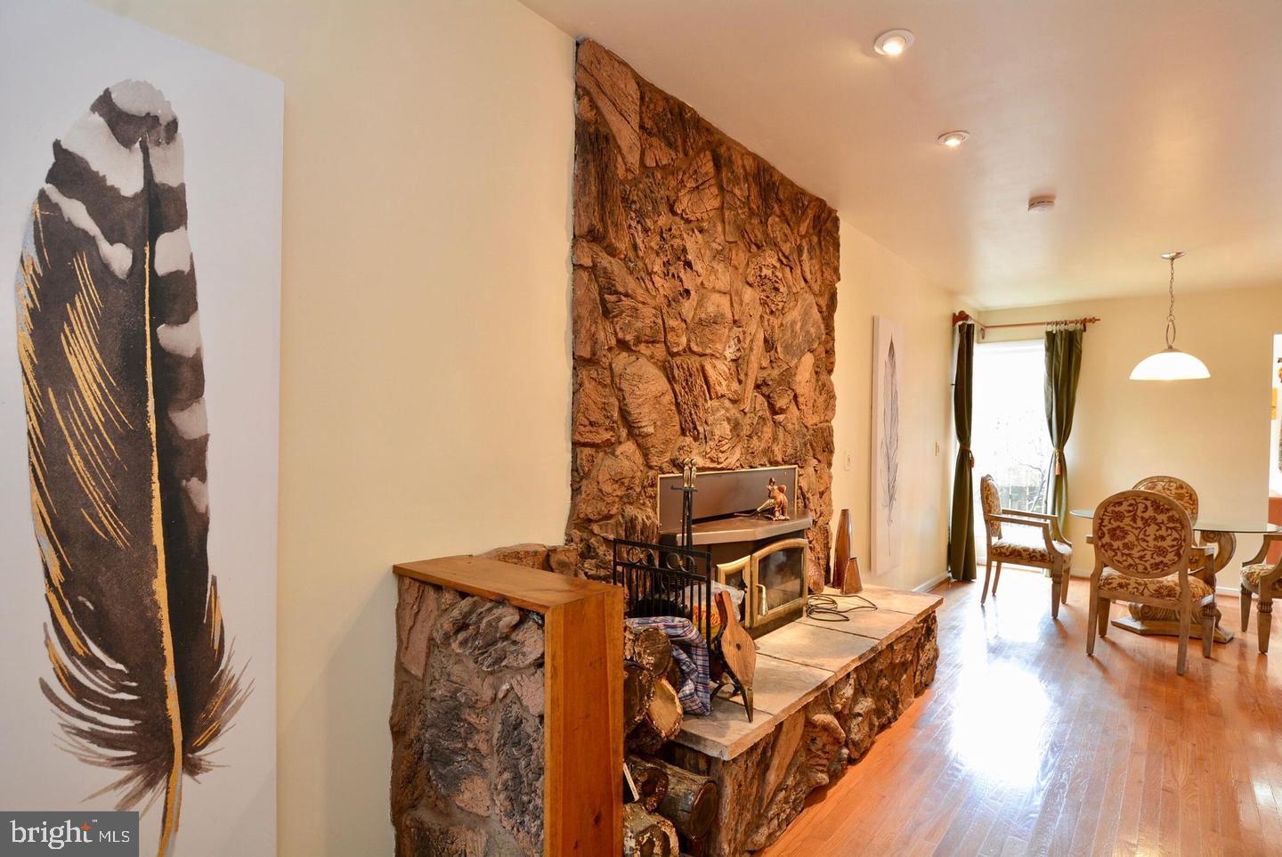8421 Alvin Road Pasadena, MD 21122 - Photo 26 of 54 a view of a hallway with couch and wooden floor