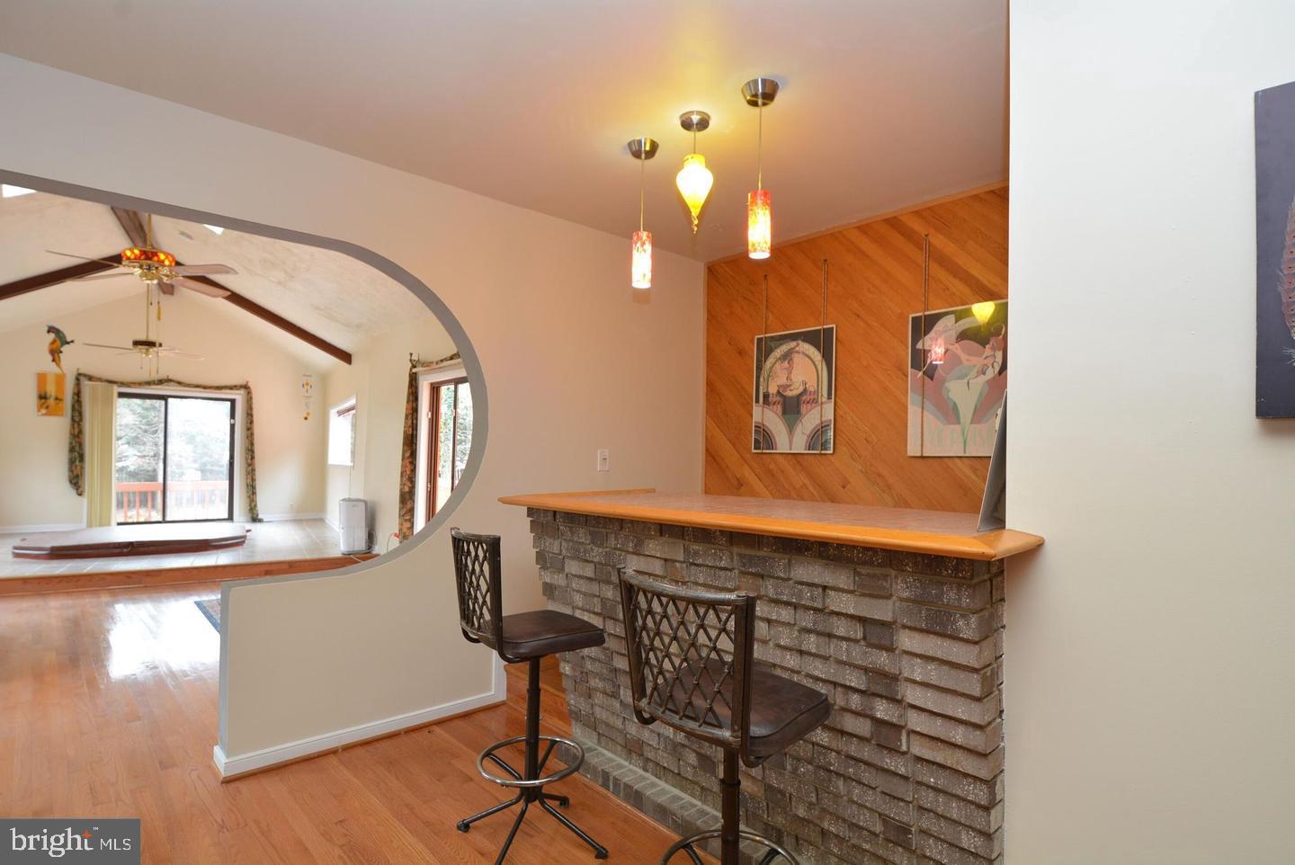 8421 Alvin Road Pasadena, MD 21122 - Photo 29 of 54 a view of a hallway with wooden floor and chandelier