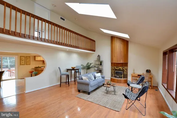 a living room with fireplace furniture and a wooden floor
