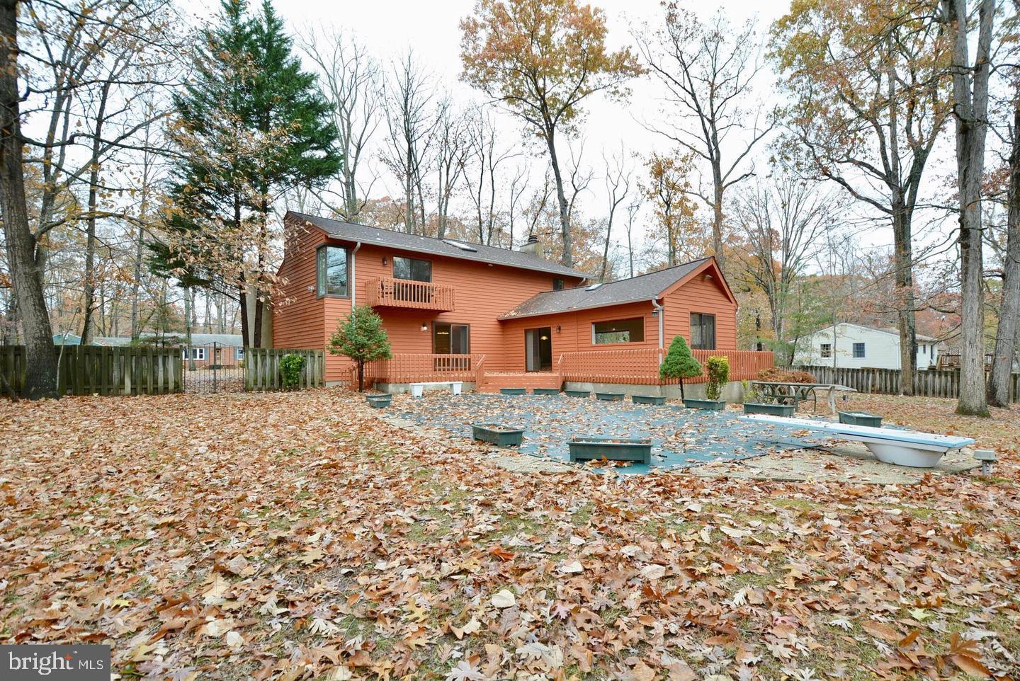 8421 Alvin Road Pasadena, MD 21122 - Photo 4 of 54 a front view of a house with a yard and garage
