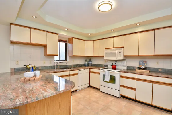 a kitchen with sink cabinets and window