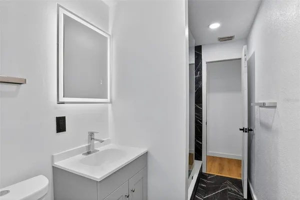 a bathroom with a sink toilet and shower