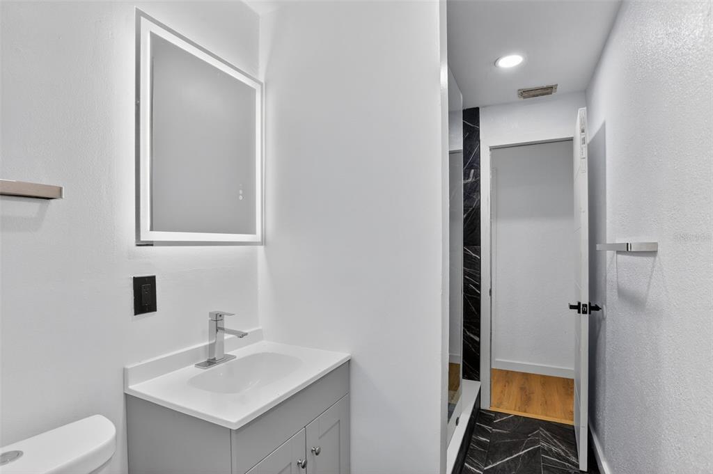 101 West Celeste Street Apopka, FL 32703 - Photo 23 of 47 a bathroom with a sink toilet and shower